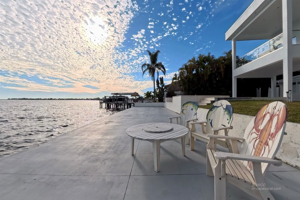 Oceanfront patio with chairs and scenic view.