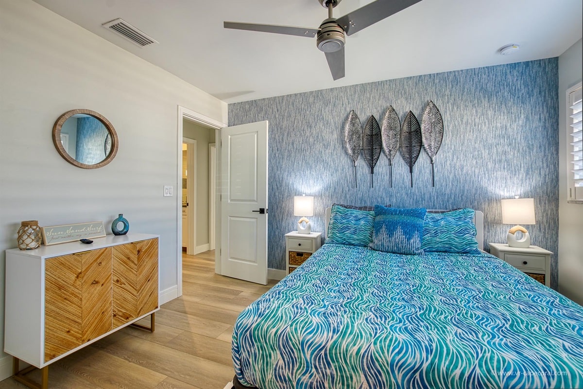 Blue themed bedroom with decorative leaves wall art