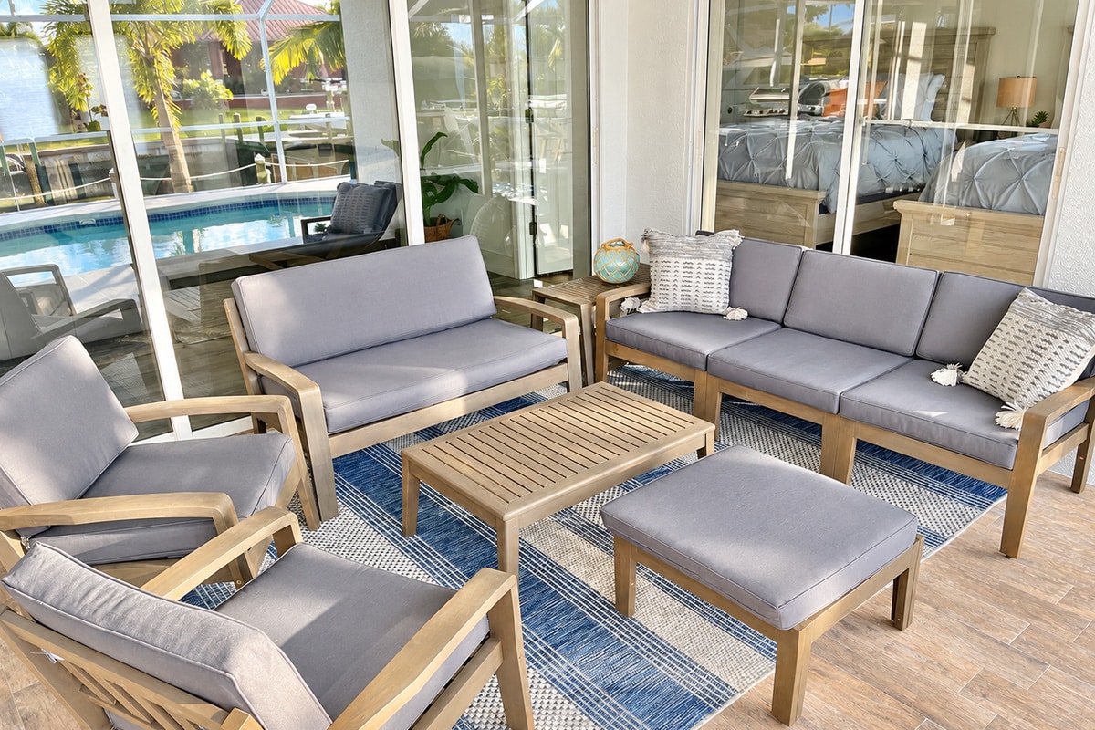 Screened patio seating overlooking a backyard swimming pool