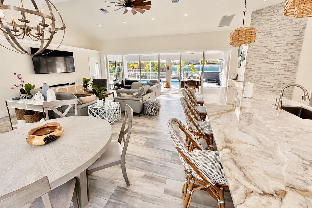 Open-plan kitchen and living room overlooking a sunny pool