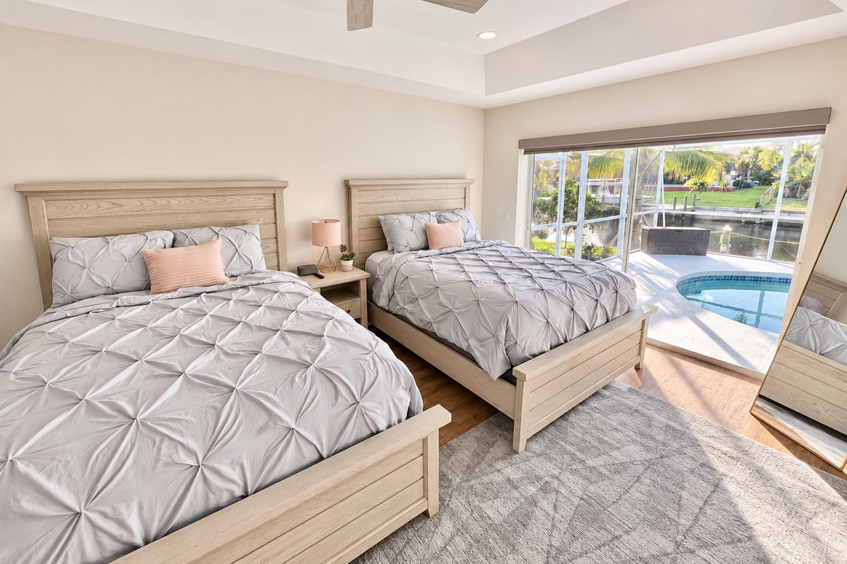 Twin bedroom overlooking pool and canal