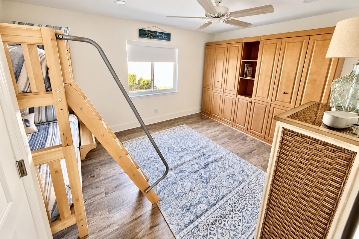 Cozy bedroom with bunk bed and built-in wooden cabinets