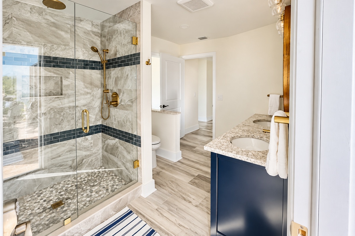 Modern bathroom with glass shower and navy vanity